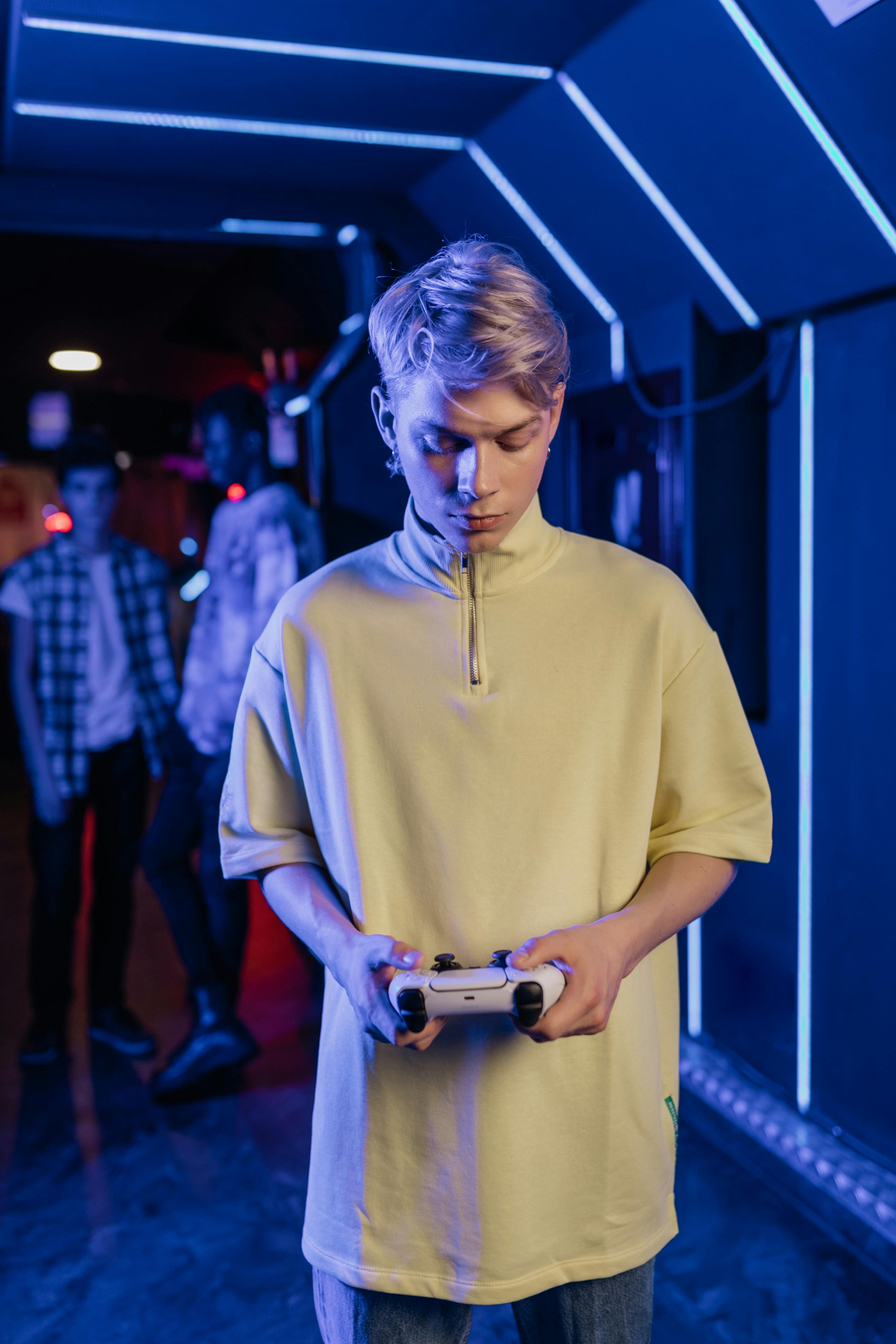 a man in turtle neck shirt holding a game controller