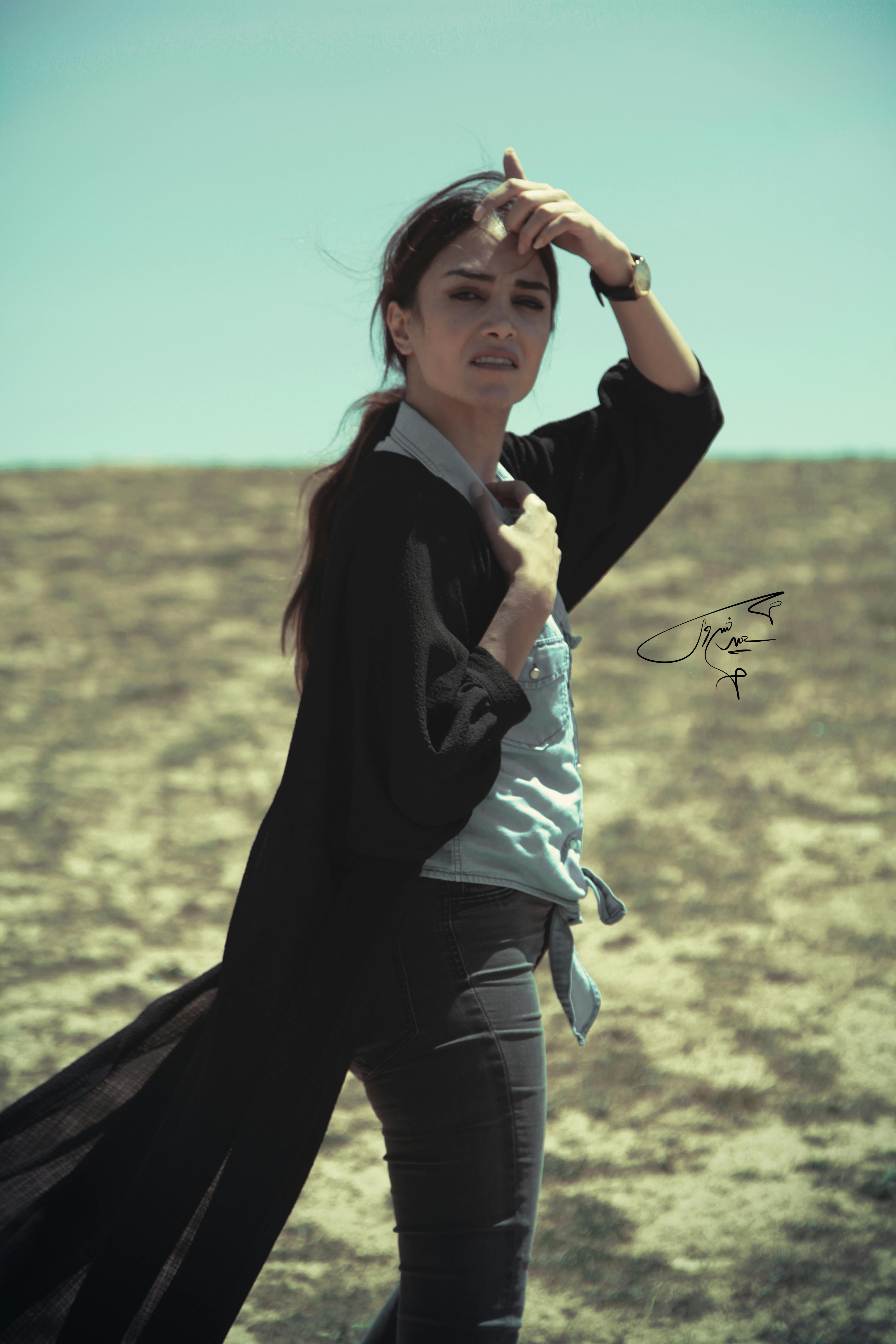 Crowd cheering inside a large e-sports arena with a stage and giant screens showing a live match