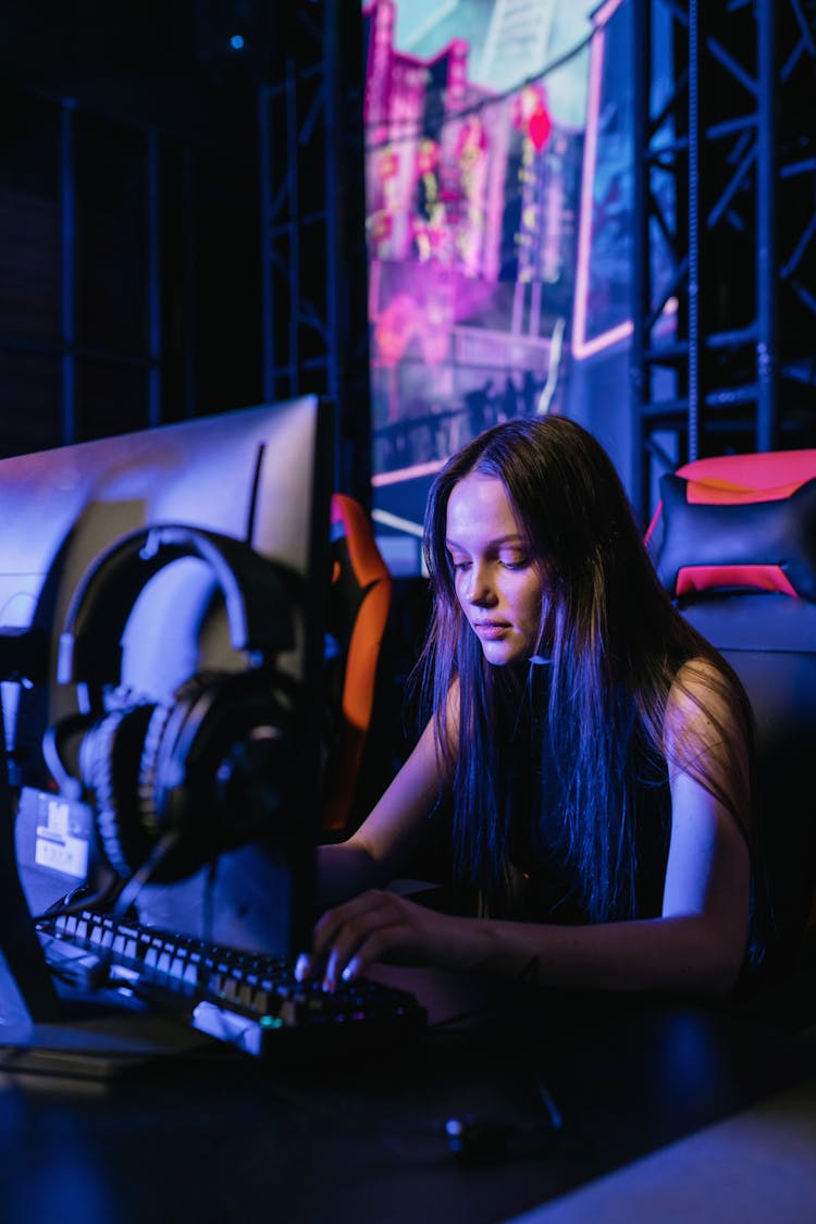 Woman Sitting On A Gaming Chair Using The Computer