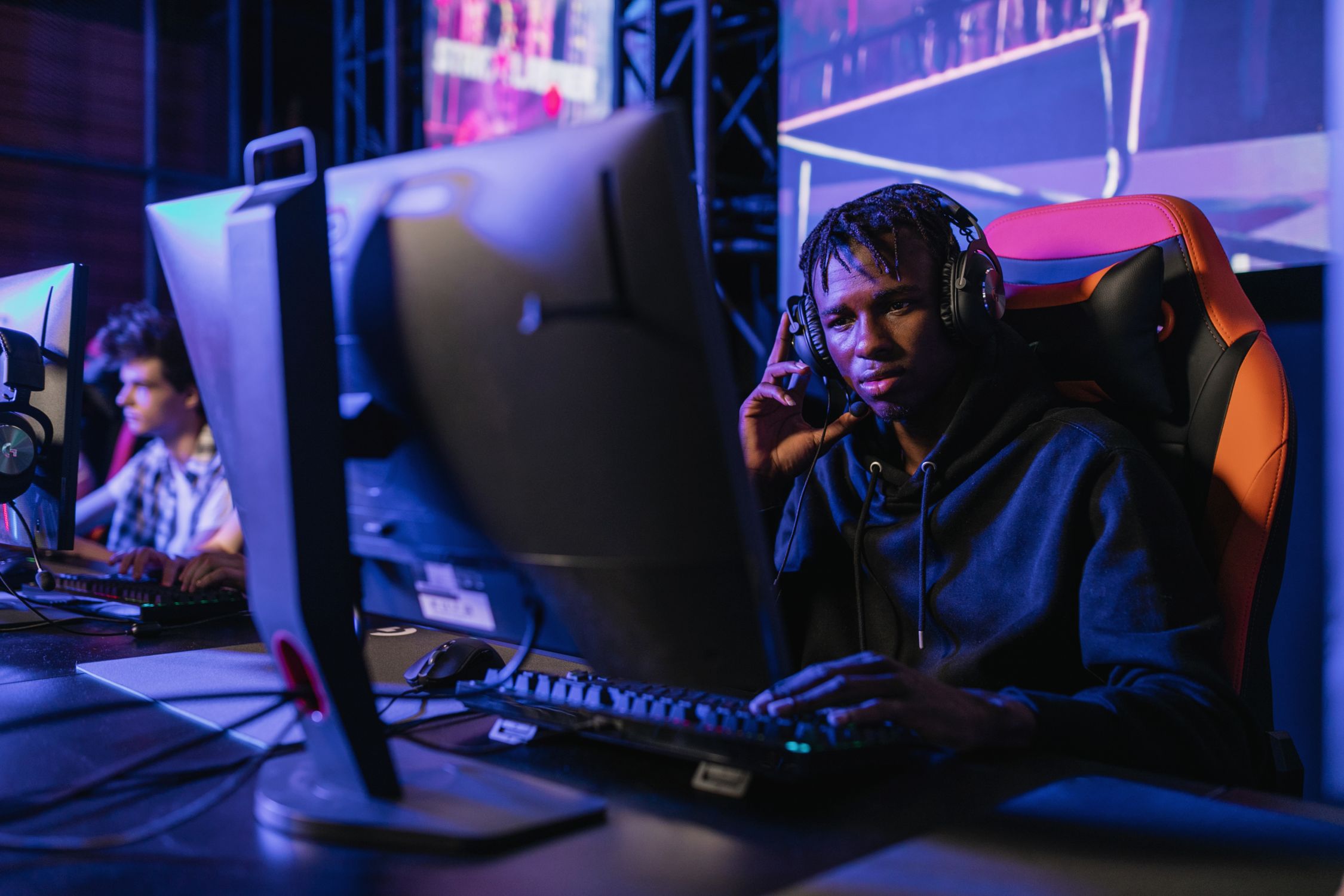 Man in Hoodie Sweater Using a Computer · Free Stock Photo