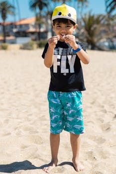 Smiling child enjoys playful day at the beach, barefoot on a sunny day.