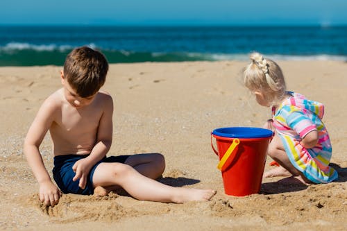 Brother and Sister Playing with Sand