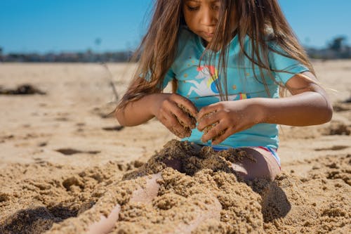 Kid Playing with Beach Sand