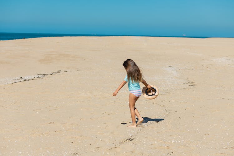 Girl Walking Barefoot On Beach Sand