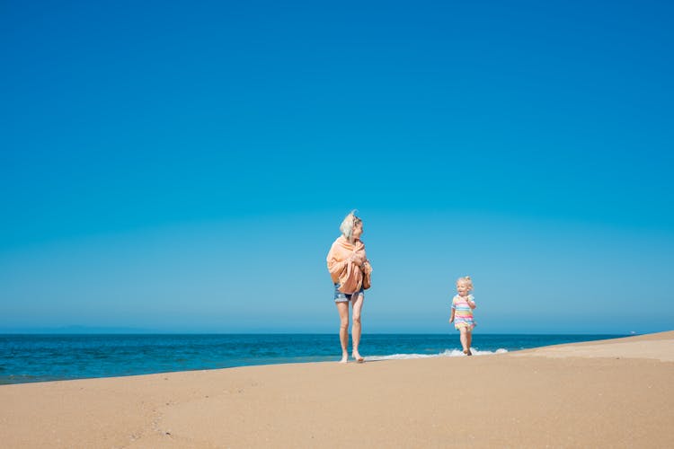 A Woman And Her Daughter At The Beach 