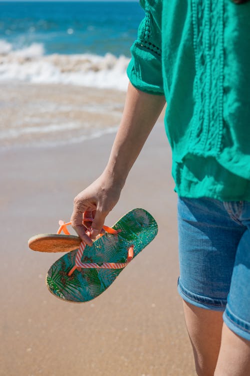 A Person Holding Flip Flops