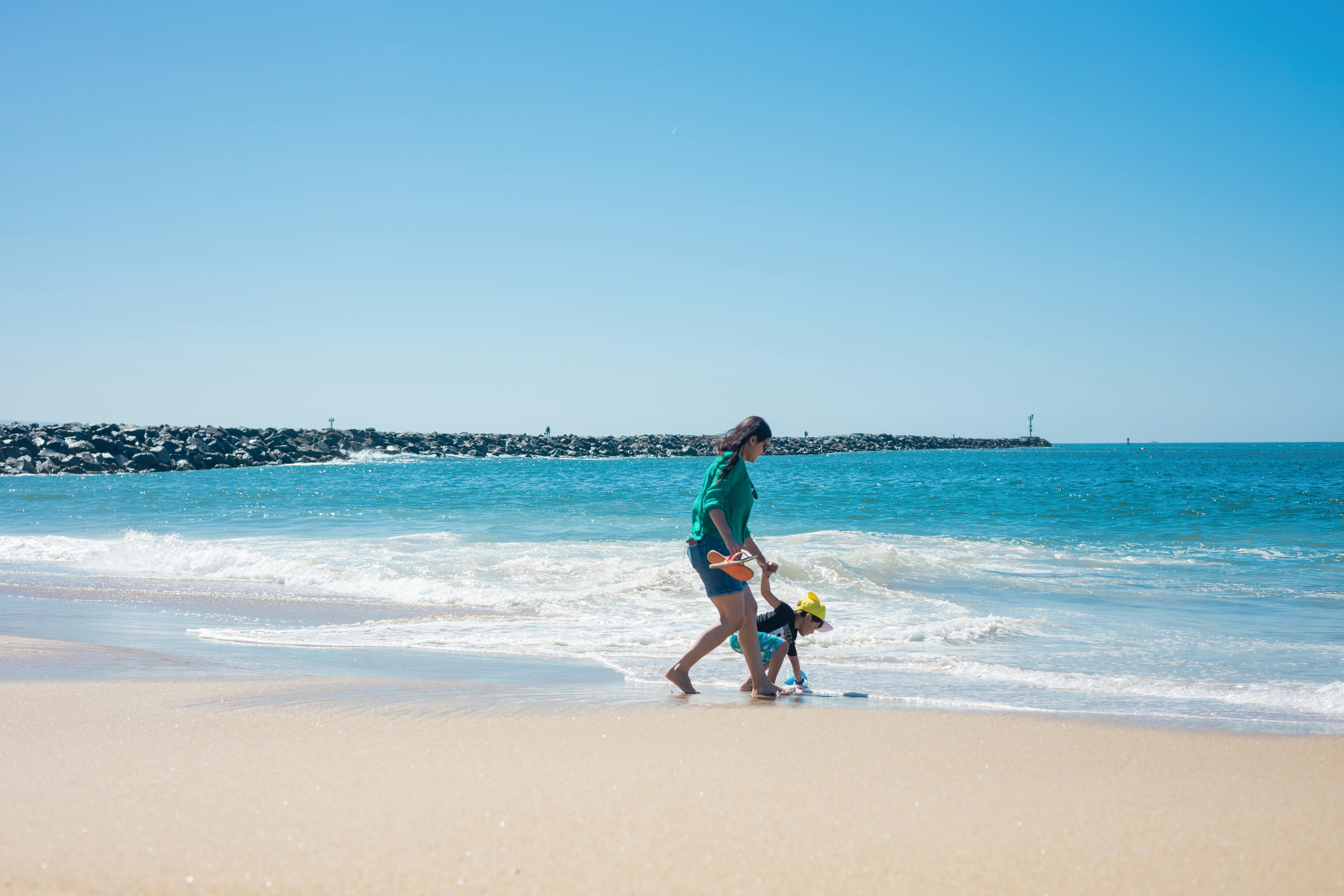 a boy and his mother at the beach