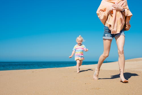 A Kid Running with Her Mother at the Beach