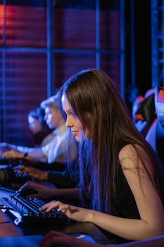 Intense focus of a woman gaming in a lively and competitive environment with vibrant lighting.