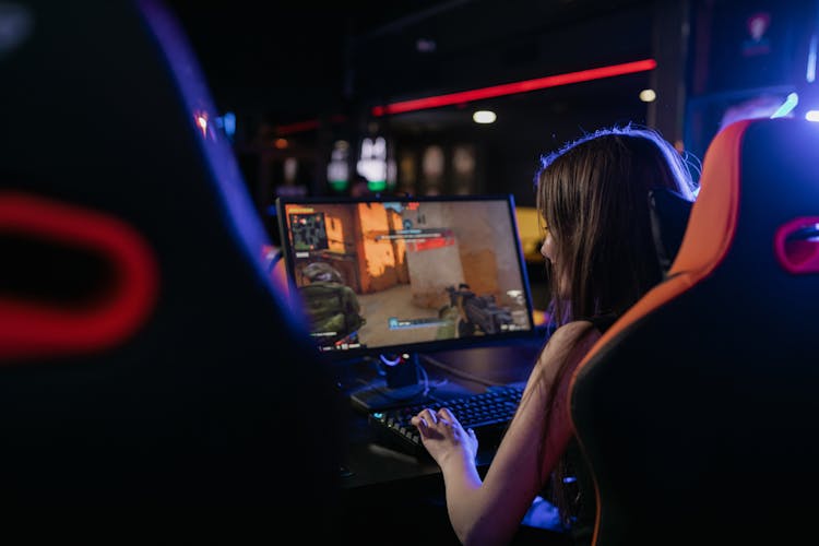 Woman In Sleeveless Shirt Playing Computer Game