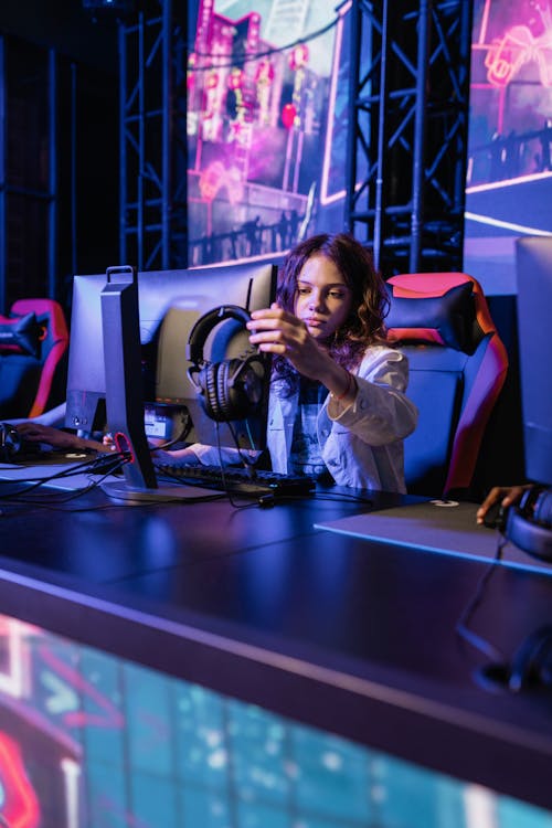 Photo of a Girl Touching a Monitor