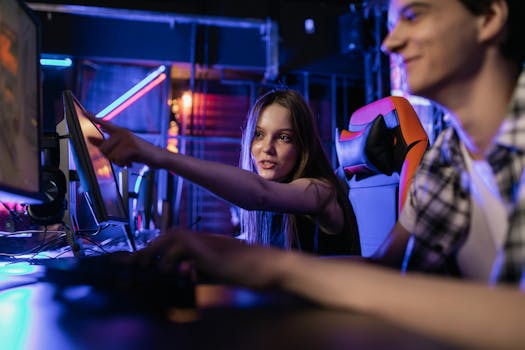 Teenagers engaging in a gaming session with illuminated monitors and vibrant LED lighting setup.