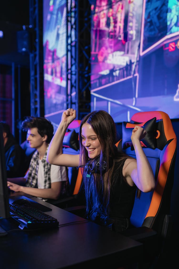 A Girl Smiling While Sitting On A Gaming Chair