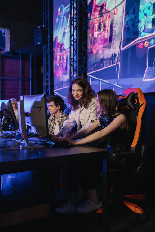 Photograph of Girls Playing Together with a Computer