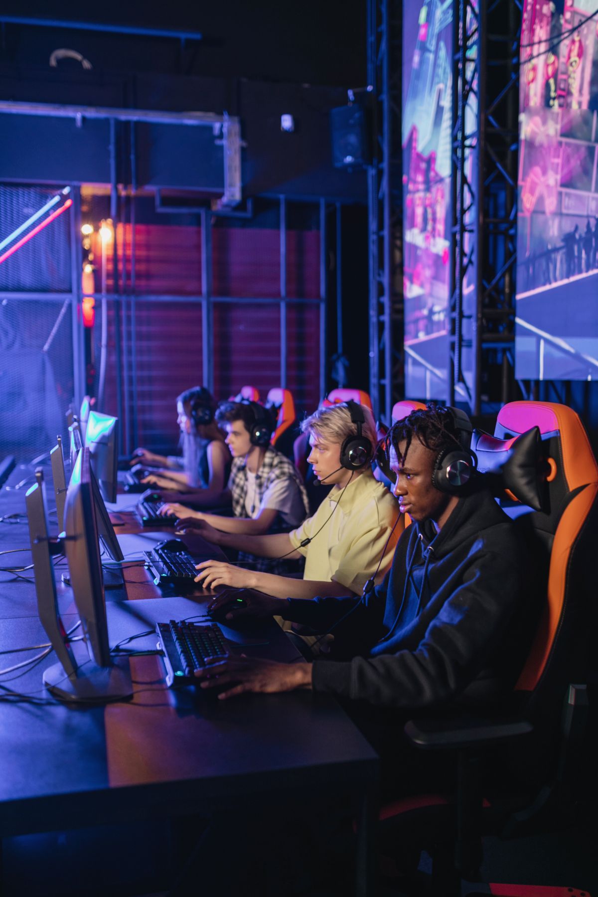 Amateur academy squad scrimmaging in a neon-lit room