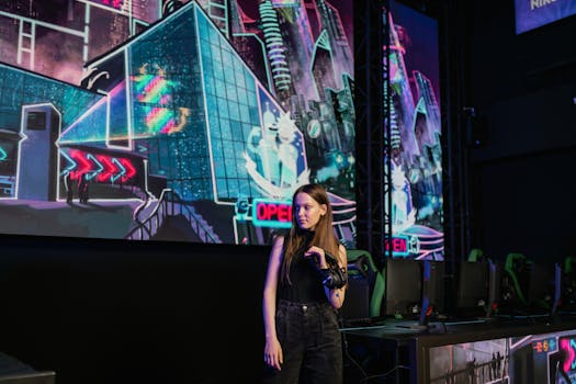 A woman stands in a virtual reality gaming arena with vibrant neon backdrops, wearing casual attire.