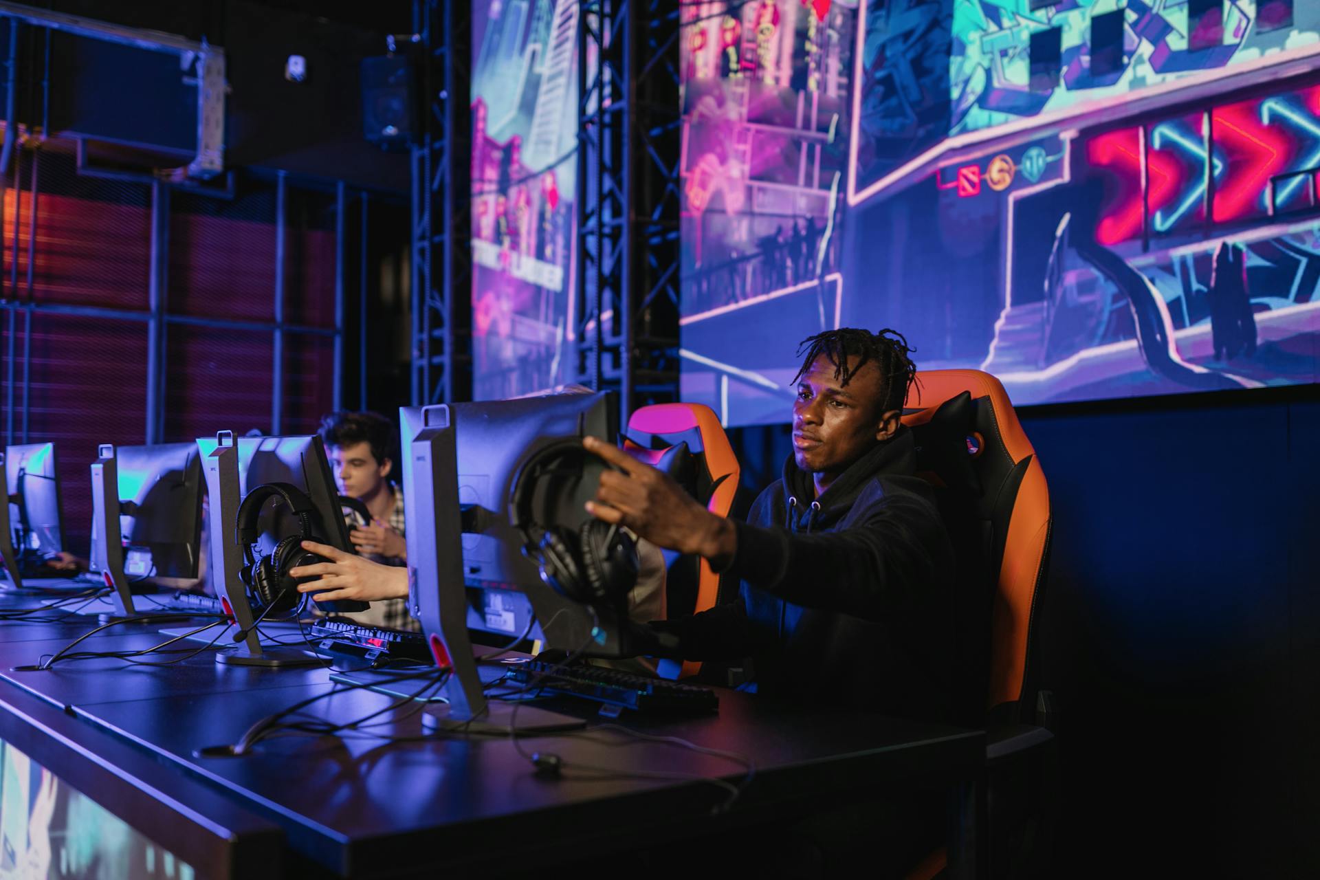 A Man in Black Jacket Sitting on Gaming Chair