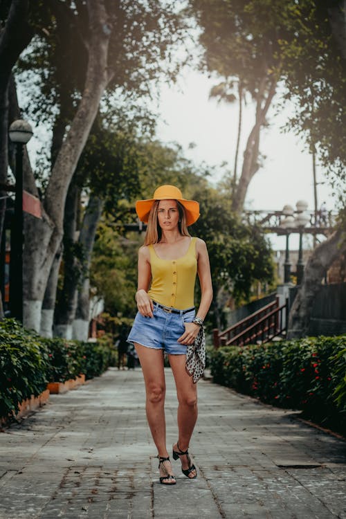Woman walking along narrow path in tropical resort
