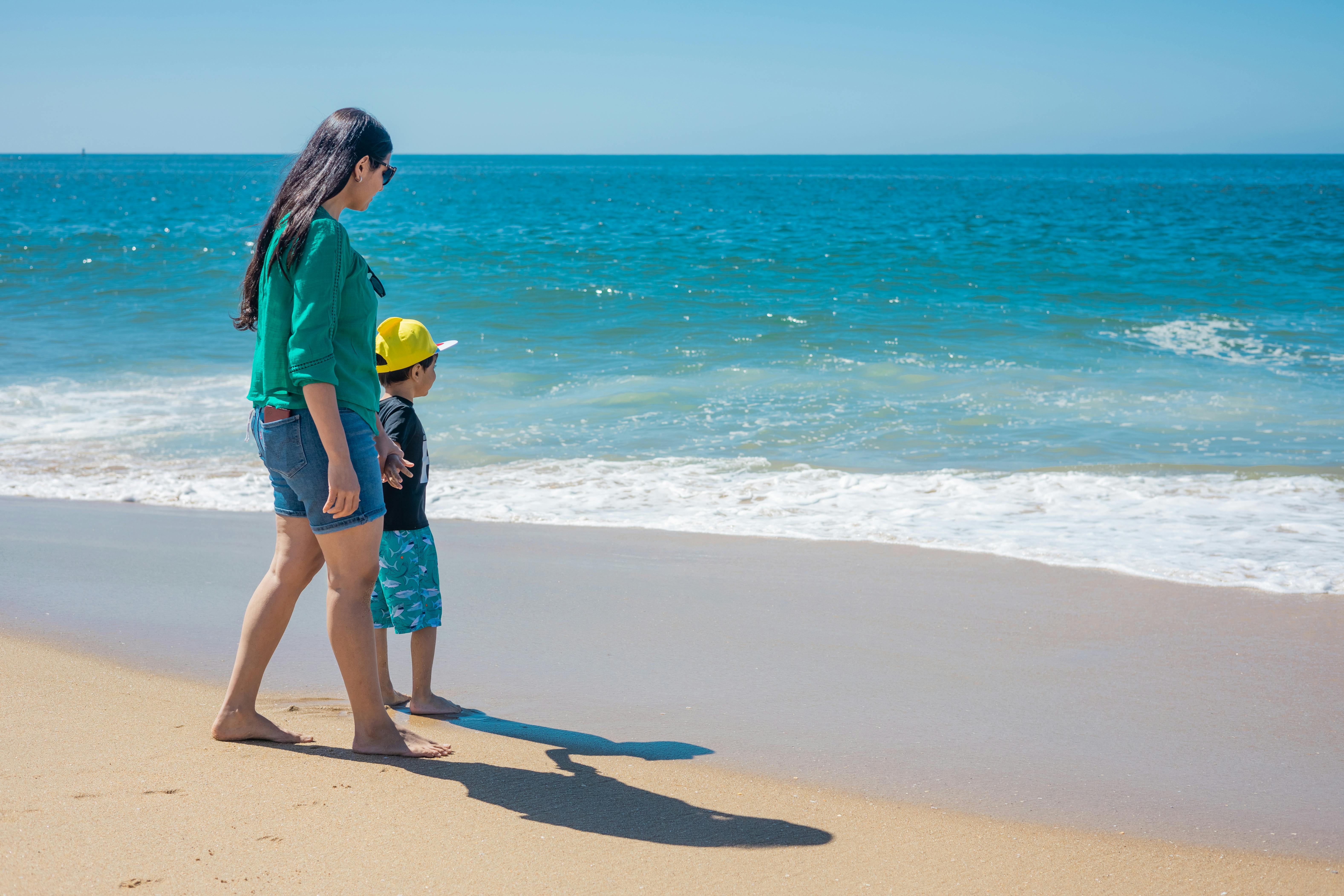 A woman and her son standing seashore. | Photo: Pexels