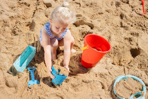 Free A Young Girl Playing on the Beach Sand Stock Photo