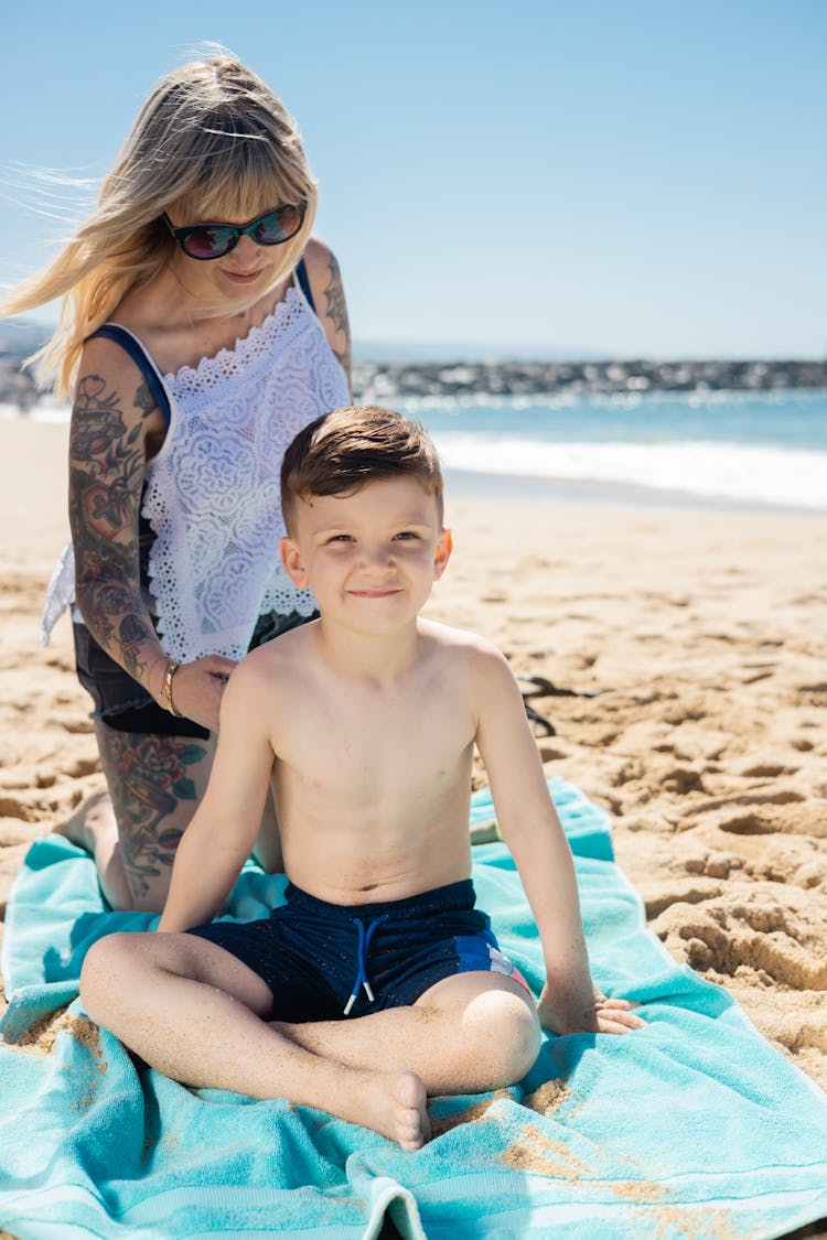 A Boy Sitting Near His Mother