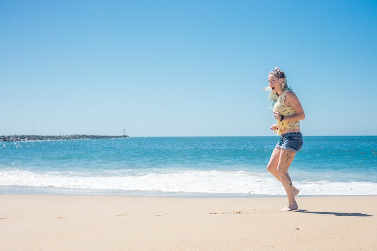 Photo Of A Woman Near The Sea