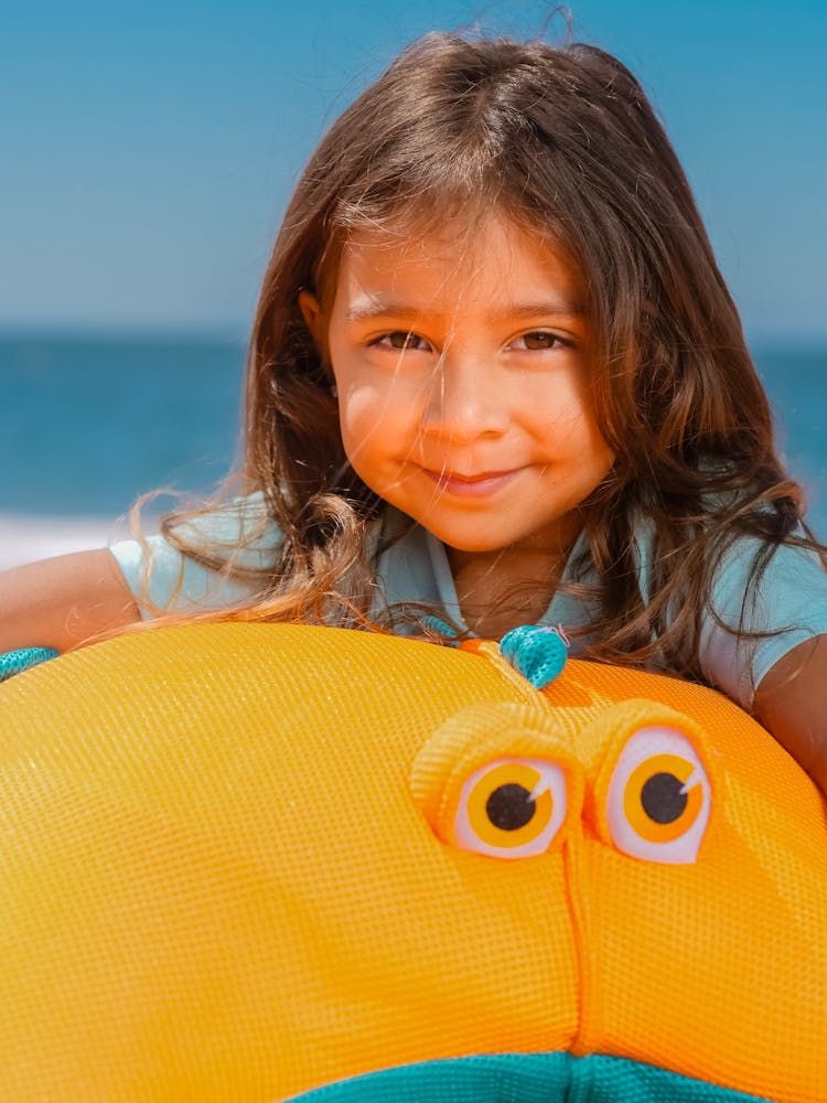 Portrait Of Girl Holding A Minion Plush Toy