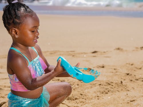 Girl in Swimsuit Playing with Beach Shavel 