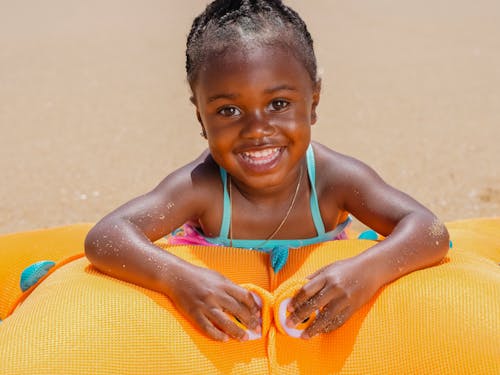 Photo of a Kid with an Orange Toy