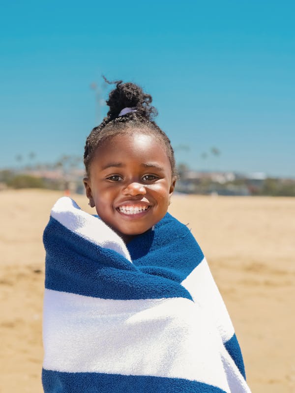 Smiling Woman in White and Blue Striped Scarf