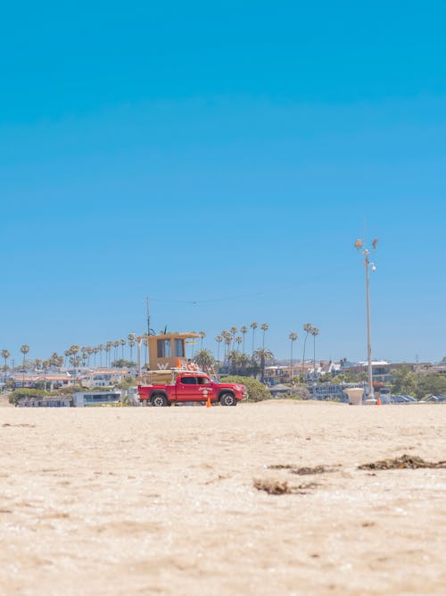 A Red Pick Up Truck at the Beach