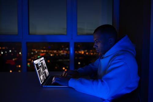 A Man using a Laptop While Working at Home