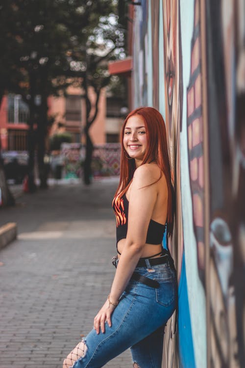 Smiling Woman Leaning on a Wall