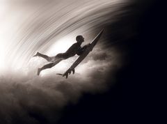 Surfer duck diving under a breaking wave on the way out