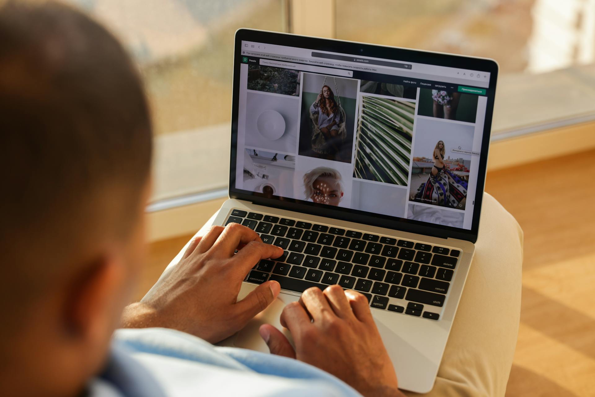 A Man Using a Black and Gray Laptop