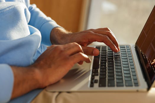 Focused image of hands typing on a laptop, ideal for business and tech themes.