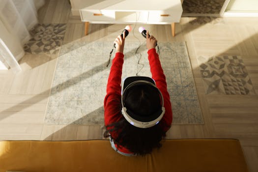 Overhead view of a woman wearing a VR headset and playing with controllers in a modern living room.