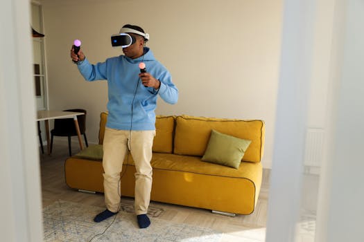 A man wearing a VR headset plays with controllers in a cozy living room.