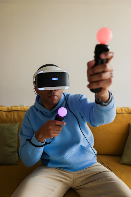 Free Man in Blue Sweater Using Virtual Reality Goggles Stock Photo