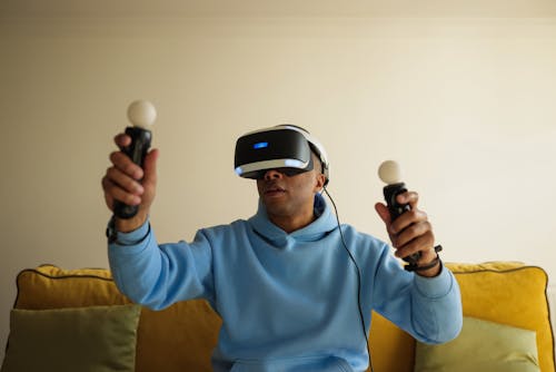 Man in Blue Hoodie Sweater Wearing Black and White Vr Goggles