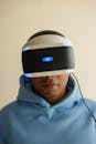 Man in Blue Hoodie Wearing Black and White Vr Goggles