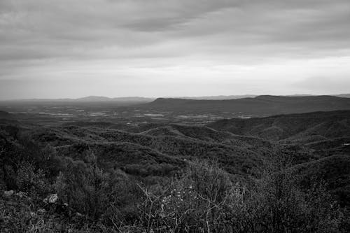 Overcast Sky Over a Hilly Landscape 