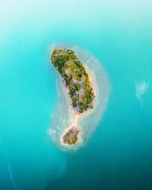 Aerial View of Green Island in the Middle of Blue Sea