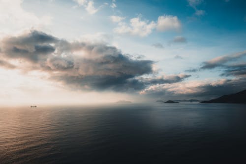 Body of Water Under Cloudy Sky