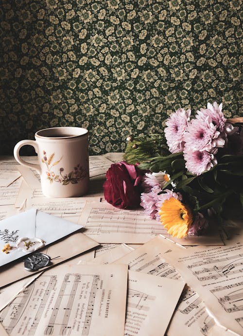 Flowers and mug on torn out pages