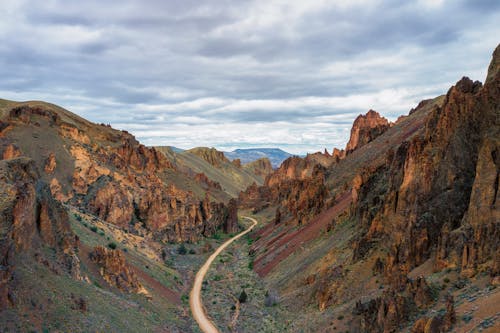 Roadway between rough rocky mountains