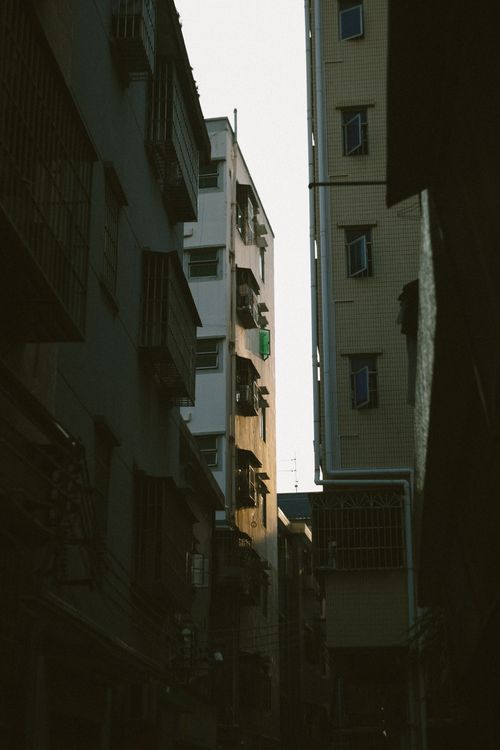 Free A narrow alleyway between urban high-rise buildings in Shenzhen, China. Stock Photo