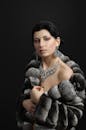 A Beautiful Lady Wearing a Gray Faux Fur Jacket and Expensive Accessories