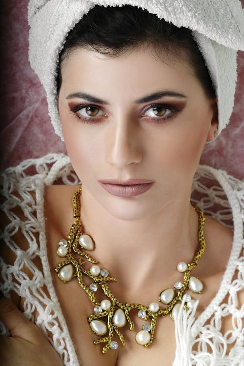 
A Woman Wearing a Gold Necklace