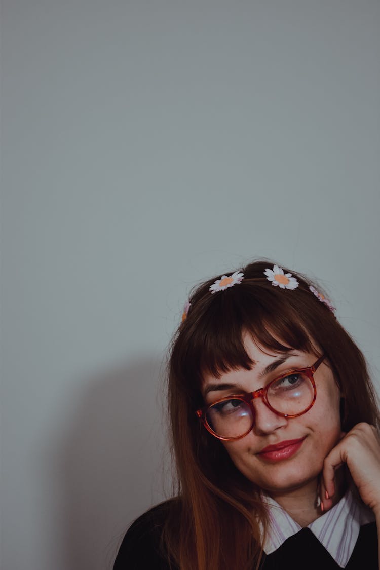 A Woman Wearing Eyeglasses And Floral Headband